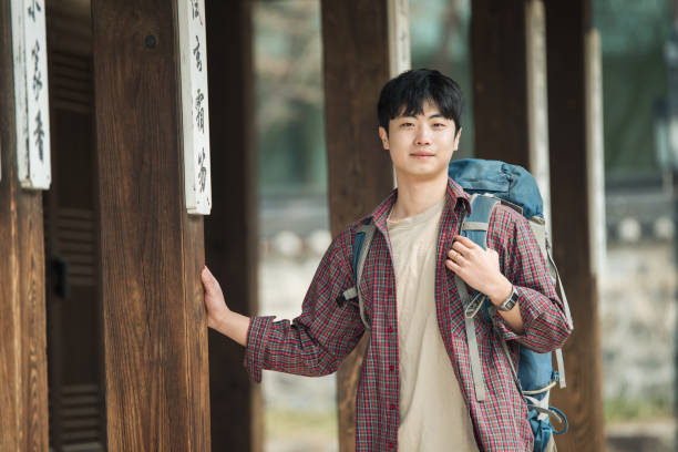 istock young man doing a backpacking trip in a Korean traditional house. 938349788