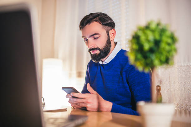 istock Young man typing on mobile phone. 938353518