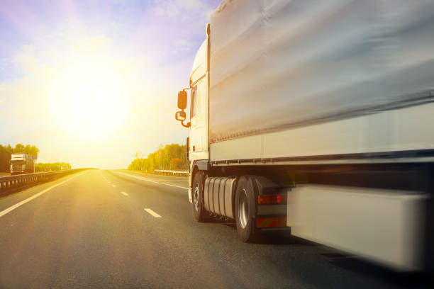 istock truck goes on the highway 938357266