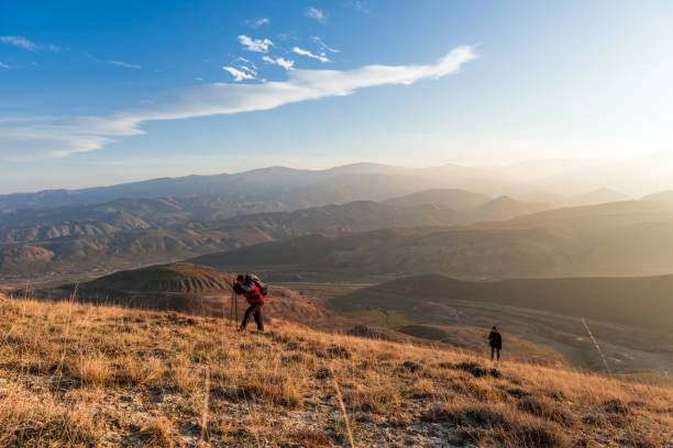 istock Travelers climbs to the mountain peak 938363360