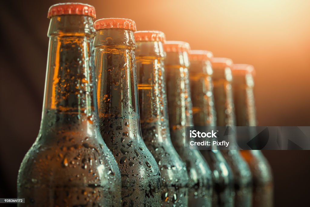 Glass bottles of beer on the dark background Beer Bottle Stock Photo