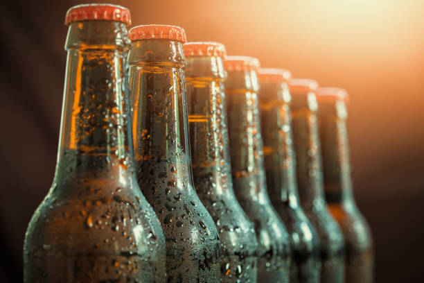 Glass bottles of beer on the dark background Glass bottles of beer on the dark background beer bottle photos stock pictures, royalty-free photos & images