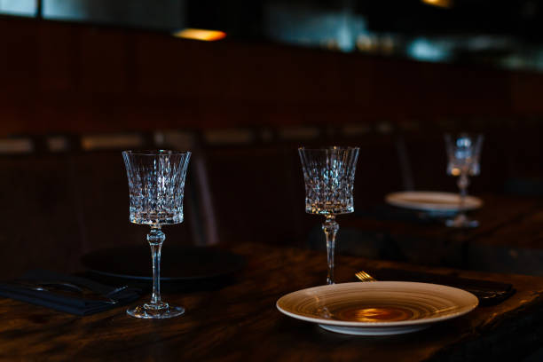 istock Two crystal champagne glasses on a dark wooden table. 938372334