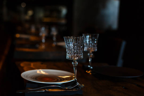 istock Two crystal champagne glasses on a dark wooden table. 938372368