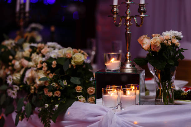 istock Main table at a wedding reception lit with fairy lights 938374976