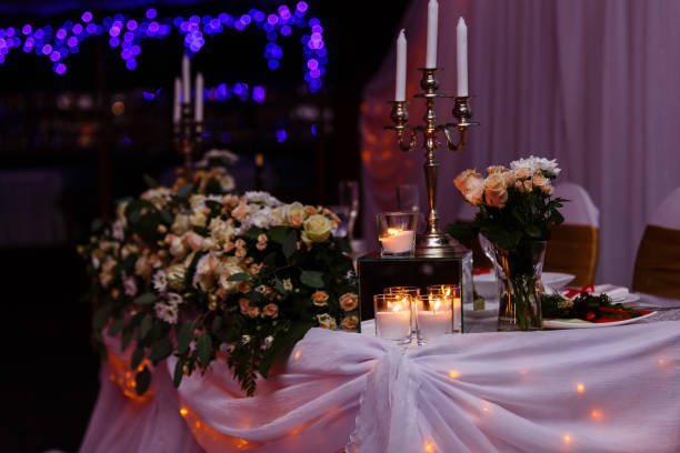 istock Antique candlestick with wedding bouquet.wedding candlestick with flower decoration before wedding ceremony.Tables set for a wedding reception 938382564