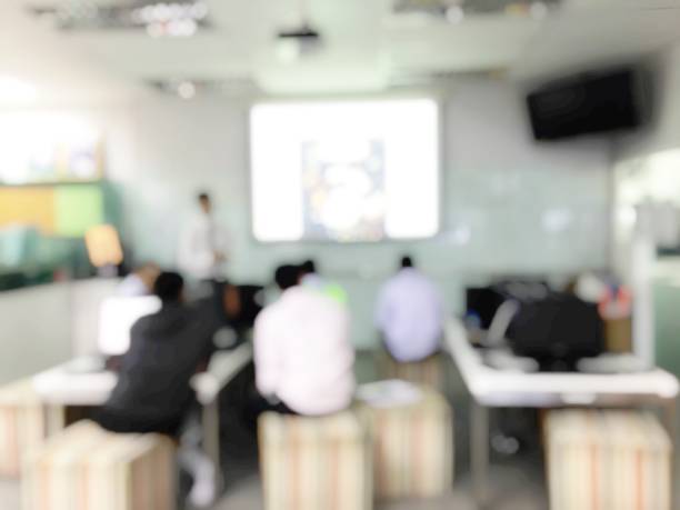istock Blurred image of students are learning and sitting at desk using computer lap together and lecture in classroom for study and workshop in computers room at school. education or training concept 938387008