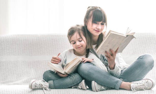 istock Mom and daughter reading a book 938388266