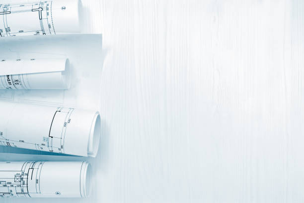 istock rolls of architectural blueprints and project plans on architect workplace 938391968