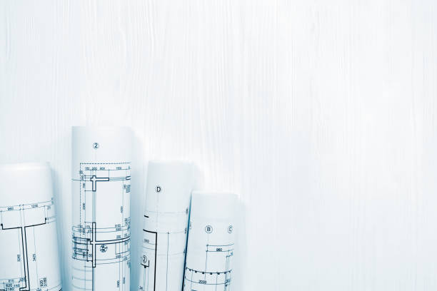 istock rolls of architectural drawings on white background 938392168