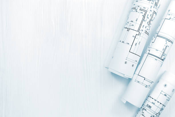 istock rolled architectural blueprints for house renovation on architect workplace 938392426