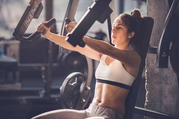 istock Athletic woman having sports training on exercise machine in a gym. 938392456