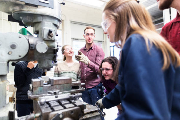 istock Students discussing the function of the machines in their mechanical engineering lab. 938399688