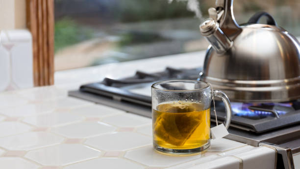 istock Tea kettle with steam and cup of tea 938401016