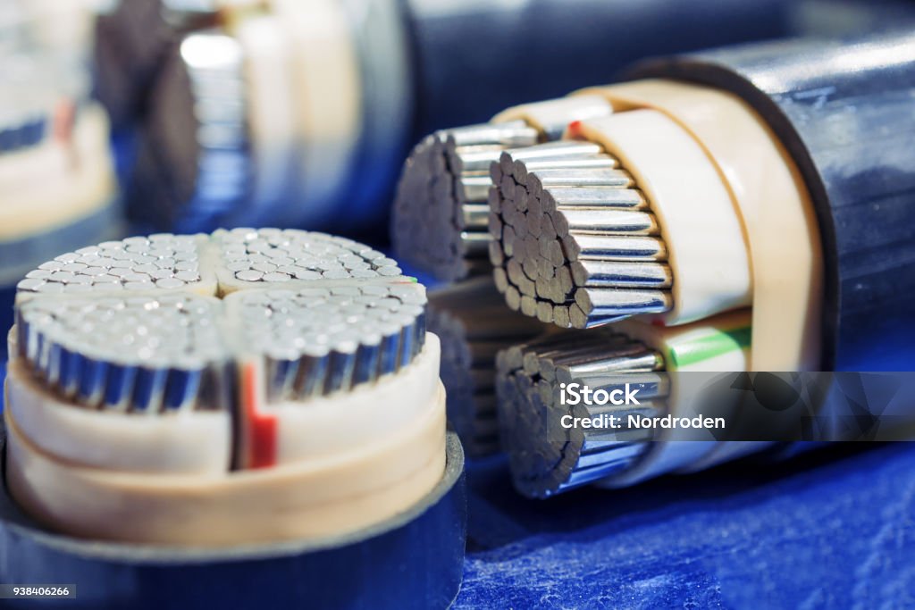 Cross section of high-voltage cable Cross section of high-voltage cable. Thick aluminum wires surrounded by a layer of polymer insulation. Cable Stock Photo