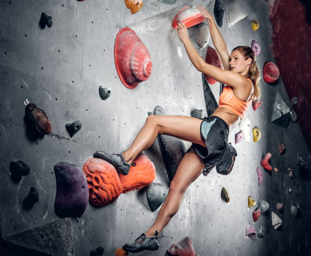 istock Female climbing on an indoor climbing wall. 938408396