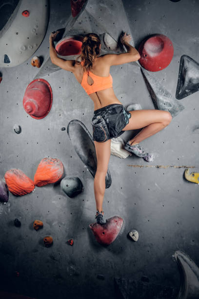 istock Female climbing on an indoor climbing wall. 938409018