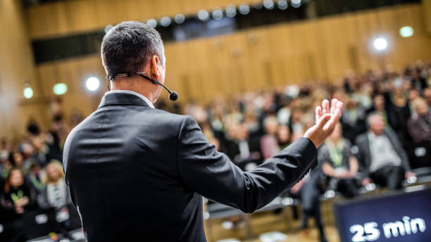 istock Businessman givng lecture at a full conference hall 938409084