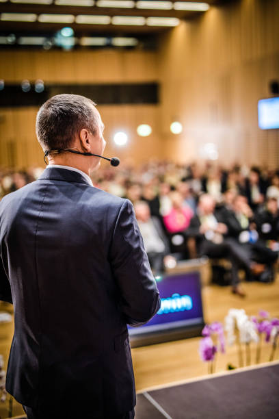 istock Rear view of a motivational coach giving a speech 938409136