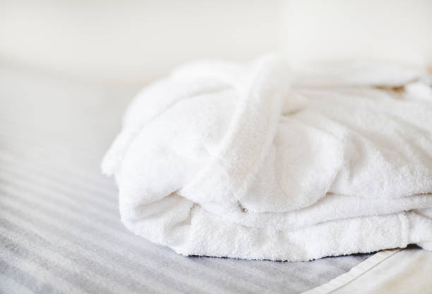 istock White bathrobe on the bed in the spa salon 938409468