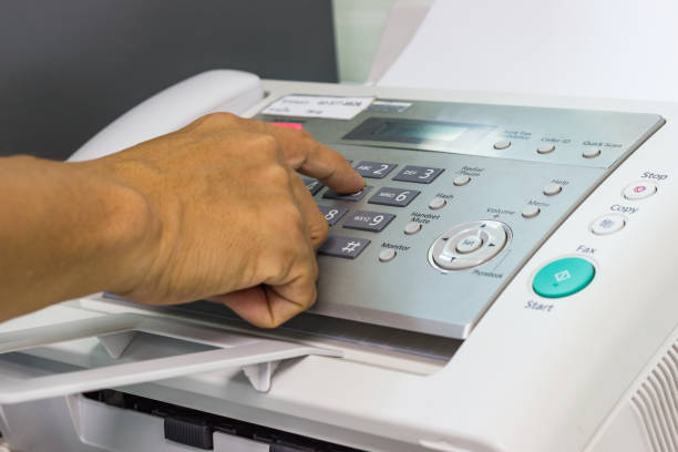 istock Men are using a fax machine in the office. Business concept 938410618