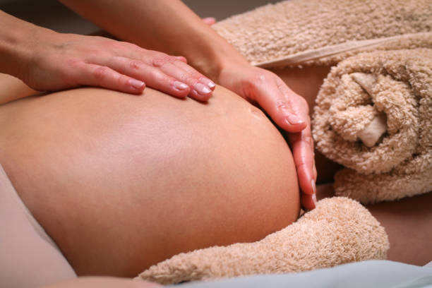 istock Massage therapist massaging pregnant woman 938411032