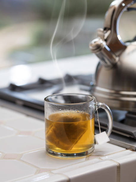 istock Tea kettle with steam and cup of tea 938413784