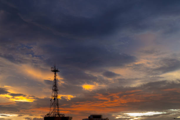istock Silhouette of cellular tower with beautiful sunset cloudy sky 938414884