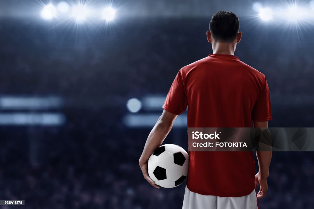 Soccer player holding soccer ball Soccer Player Stock Photo