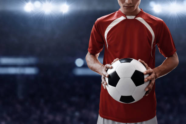 istock Soccer player holding soccer ball 938418180