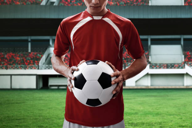 istock Soccer player holding soccer ball 938418184