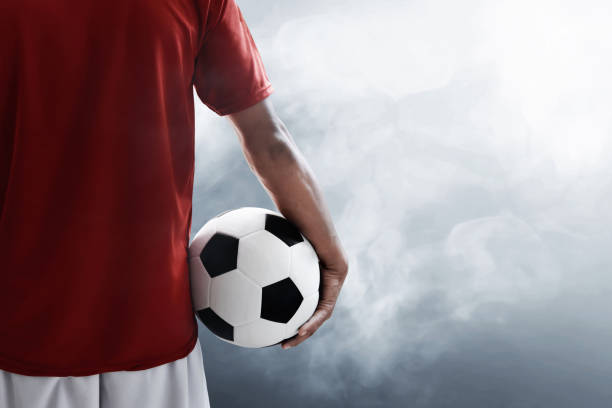 istock Soccer player holding soccer ball 938418258