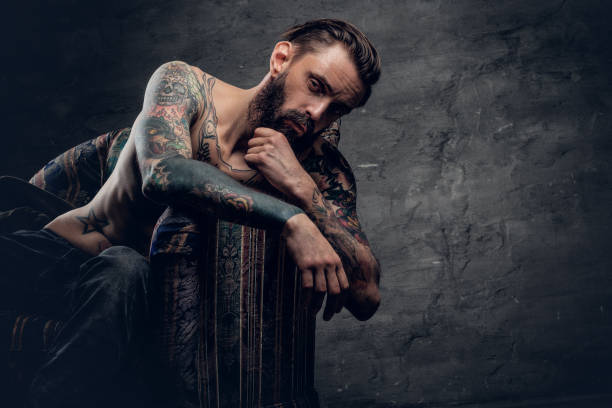 istock bearded male with naked tattooed torso. 938419556