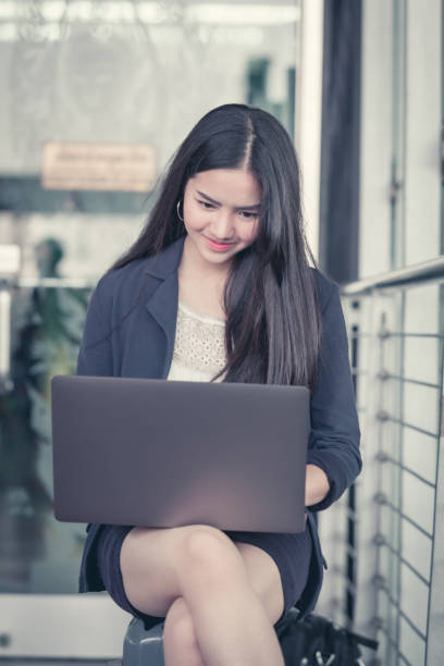 istock Beautiful business woman sitting on suitcase. 938422250