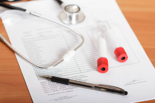 istock Test tubes for blood, phonendoscope, examination results on table 938422816