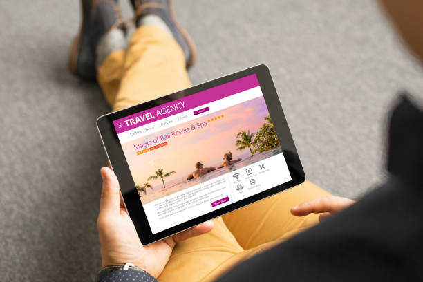 istock Man looking at exotic travel destinations online 938423134