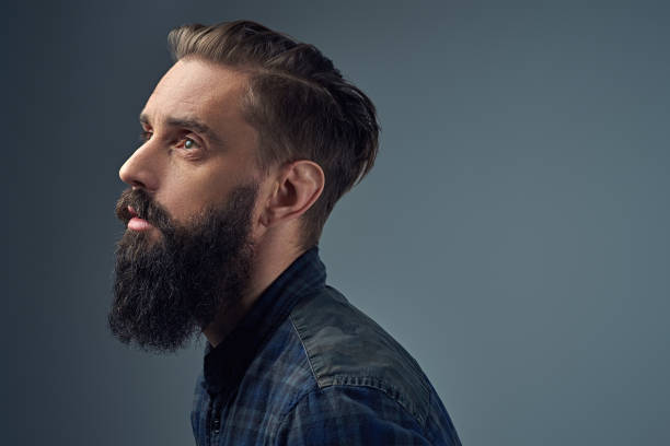 istock Side view of bearded male over grey background. 938429772