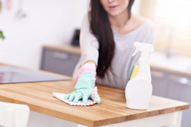 istock Beautiful young woman cleaning the kitchen 938430194
