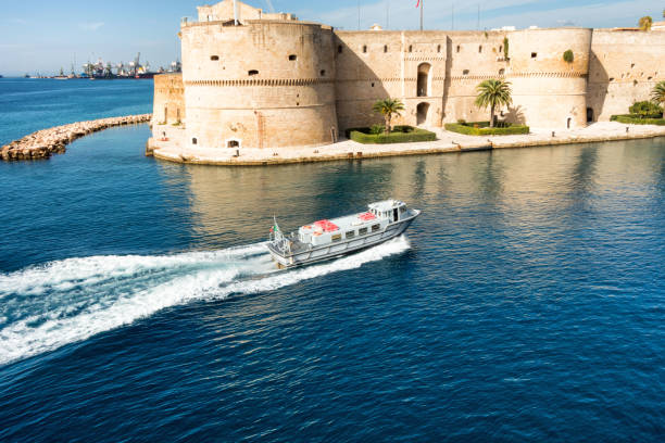 The Aragonese castle located on the shore of the sea in Taranto. Taranto, Italy - November 03, 2017: Aragonese castle is the main attraction of the Italian city of Taranto. taranto stock pictures, royalty-free photos & images