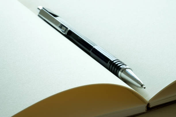 istock Top view of businessman  blank notebook business document black pen 938437900