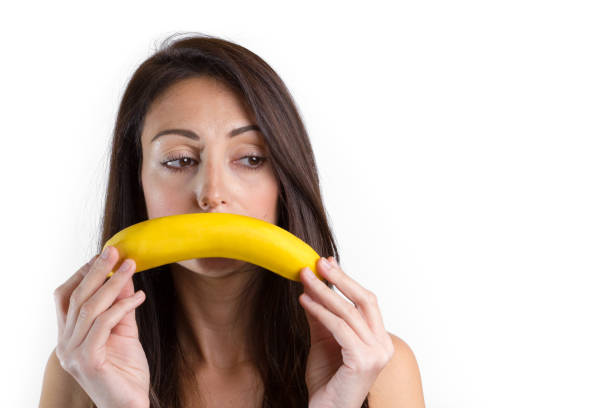 istock Young sad woman with banana 938438208