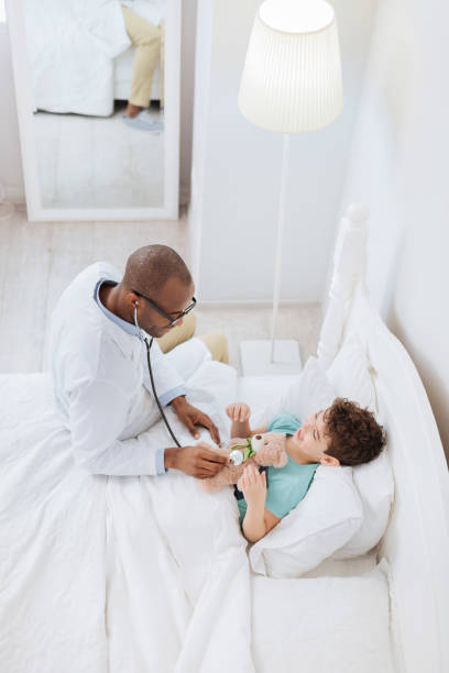 istock Skillful male doctor diagnosing plush bear 938438576