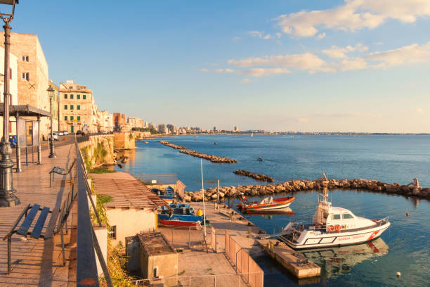 Boat station, located on the shore of the Ionian sea in the Italian city of Taranto. Taranto, Italy - November 04, 2017: View of the boat station and coastline of Taranto, located on the Ionian sea in southern Italy. taranto stock pictures, royalty-free photos & images