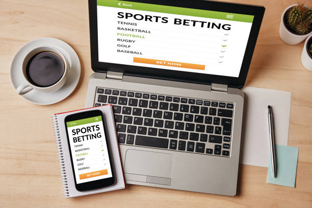 Sports betting concept on laptop and smartphone screen stock photo