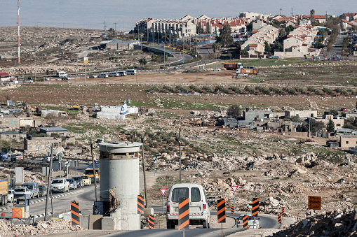 Jerusalem, Palestine, January 12, 2011: Road check point leading to Jewish settlement built on the grounds which are recognized as Palestinian Occupied Territories by international law, and seen as illegal, east of Jerusalem.