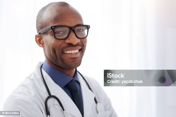 Jovial Male Doctor Smiling To Camera Stock Photo - Download Image Now - Doctor, Happiness, Healthcare And Medicine