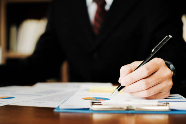 istock businesspeople working and discussing new plan project in office with document, business concept 938443022