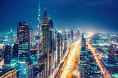 Scenic nighttime skyline of a big modern city. Dubai, UAE.