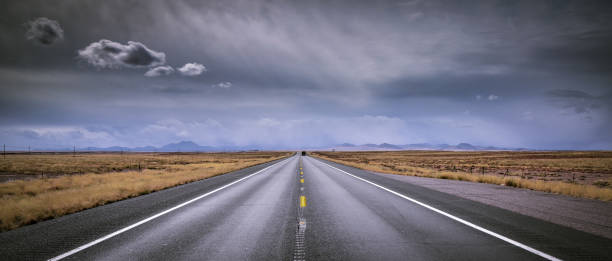 istock Dramatic skies on road trip open road 938453762