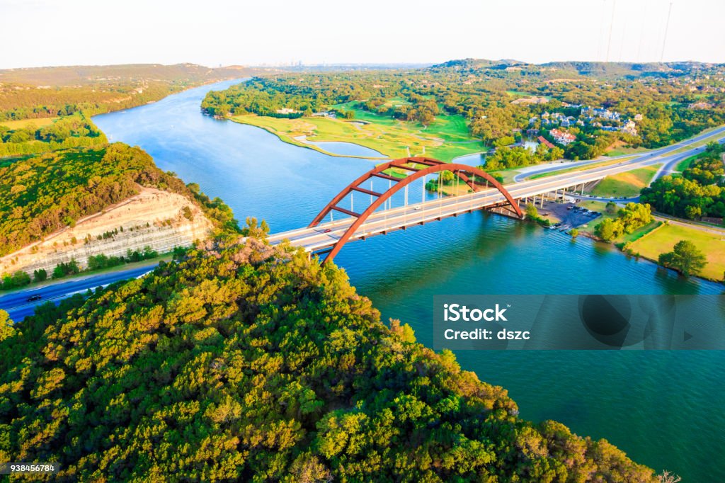 Pennybacker 360 bridge, Colorado River, Austin Texas, aerial panorama Panoramic aerial view from helicopter of 360 bridge on Colorado River near Austin Texas, looking east.
Austin city skyline visible in far distance. Austin - Texas Stock Photo